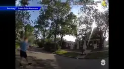 Tampa police officer helps child practice basketball